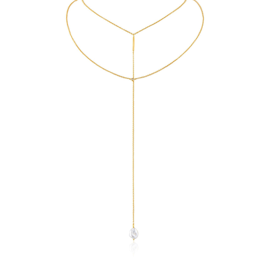 Gold Pearl Y Necklace Crafted with sweeps of delicate chains, the necklace pairs a choker and chain with a single drop, finished with a baroque fresh water pearl   Material: 14kt gold plated on sterling silver with baroque pearl