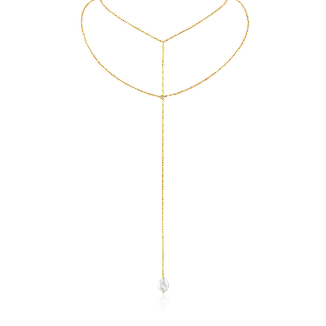 Gold Pearl Y Necklace Crafted with sweeps of delicate chains, the necklace pairs a choker and chain with a single drop, finished with a baroque fresh water pearl   Material: 14kt gold plated on sterling silver with baroque pearl